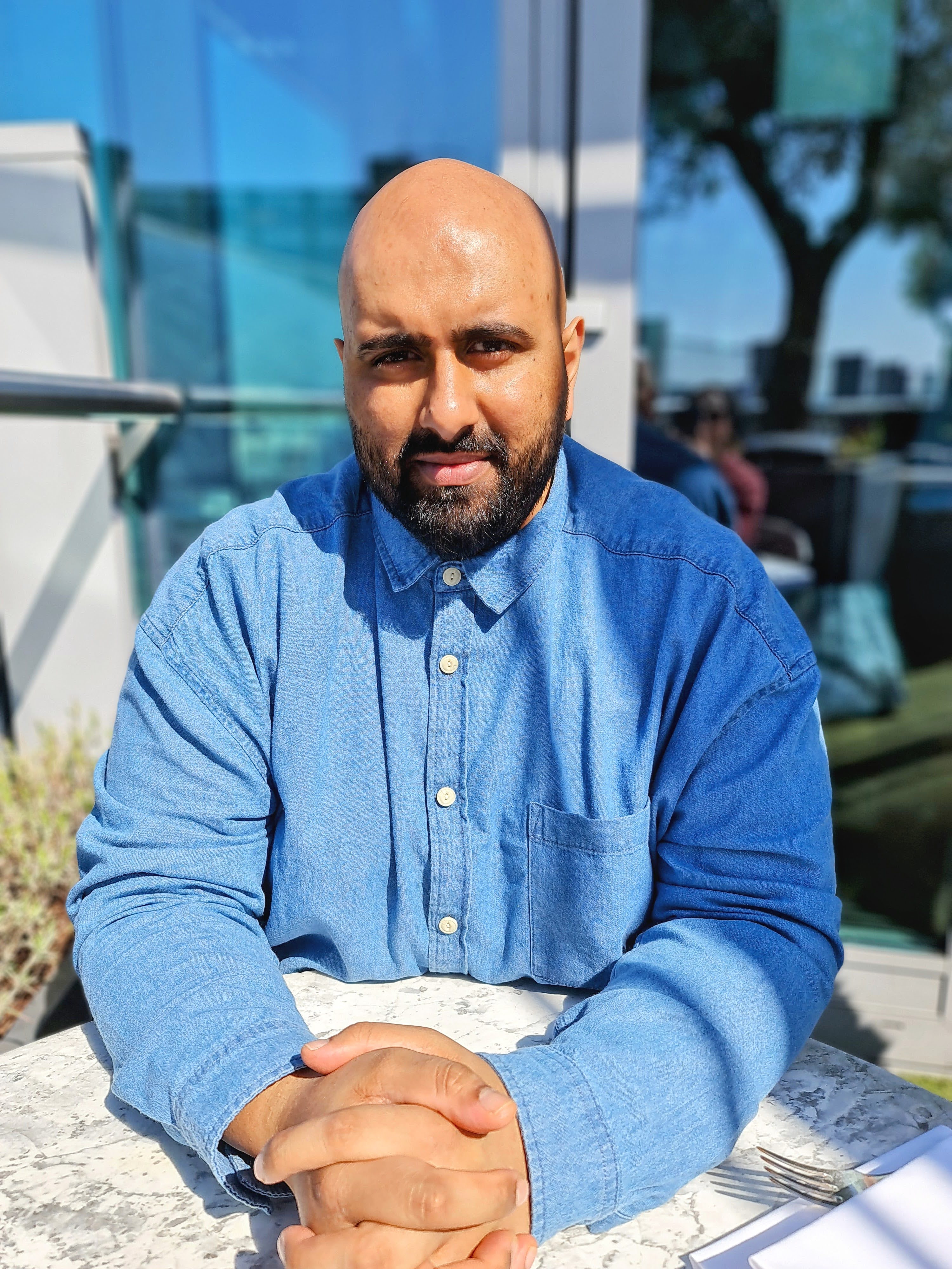 Dr. Bilal Hassam in a blue shirt
