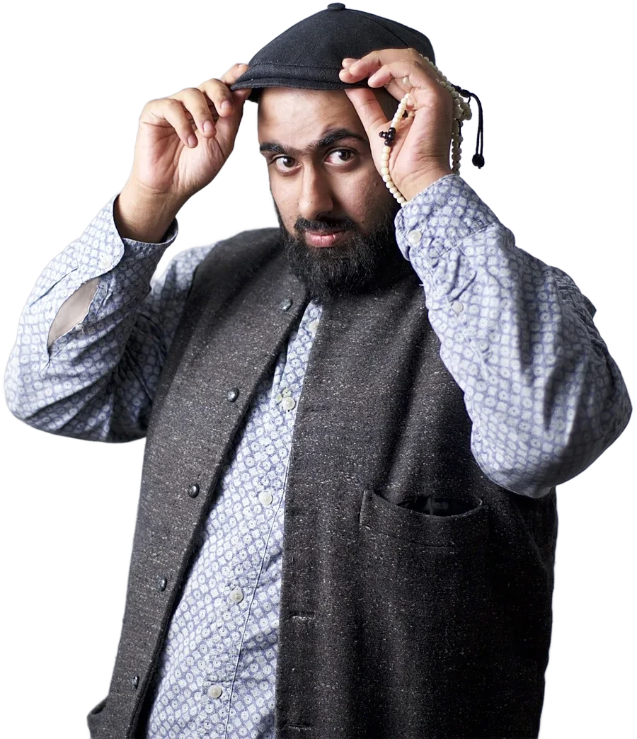 Dr. Bilal Hassam adjusting his cap, wearing a patterned shirt and grey waistcoat